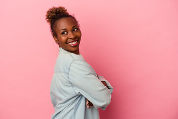 Young african american woman isolated on pink background laughing and having fun.