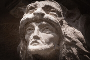 Fragment of an ancient stone statue of Hercules wearing Nemean lion skin. Close up.