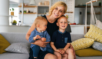 Young mother with two children having fun and love.