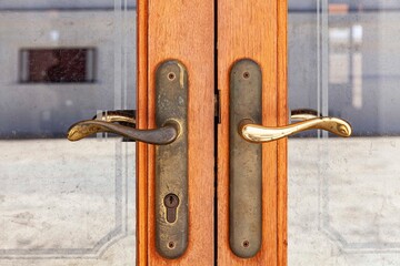Variety of knockers and handles on ancient doors, Old metal door handle on a wooden door