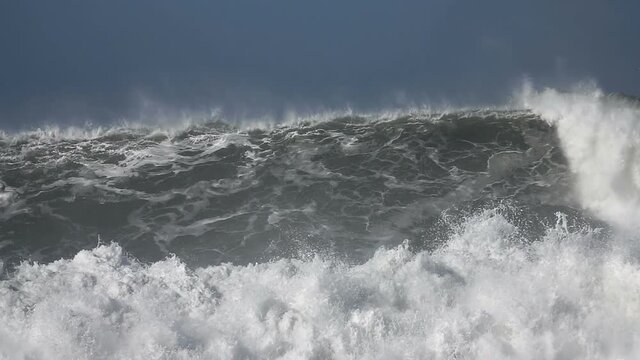 Very Big wave. Ocean giant wave splashing. Sea flooding. Blue sky.
