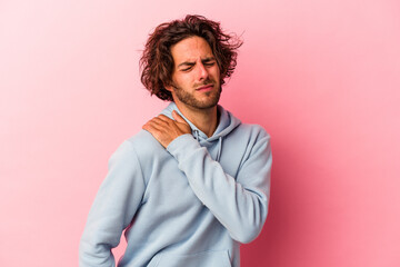 Young caucasian man isolated on pink bakcground having a shoulder pain.