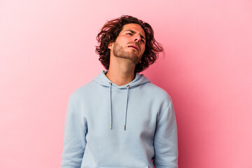 Young caucasian man isolated on pink bakcground shouting very angry, rage concept, frustrated.