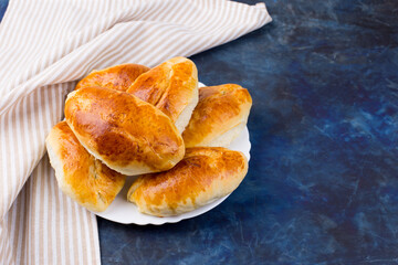 Delicious little pies with green onion and egg. Traditional Russian cuisine. Homemade cakes.