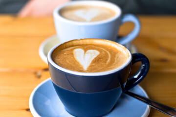 coffee with a heart in the middle in a blue cup