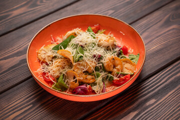 Caesar salad with chicken with grated cheese and cherry tomatoes