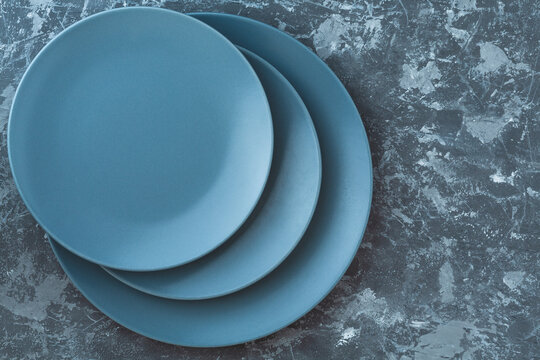 Top View Of Grey Empty Plates On Dark Grey Concrete Background