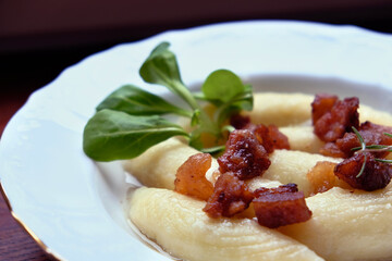 Dough dumplings with cracklings and herbs