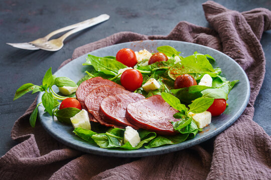 Dry-cured beef with spinach feta tomatoes salad