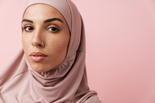 A Close-up View Of The Muslim Woman In Pink Hijab Looking At The Camera