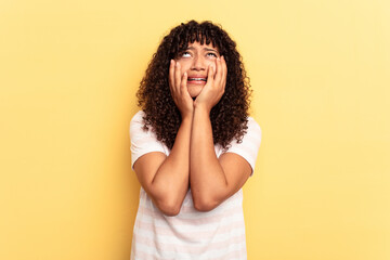Young mixed race woman isolated on yellow background whining and crying disconsolately.