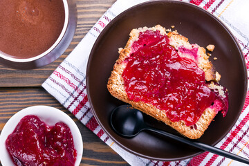 yeast dough with jam served with hot chocolate