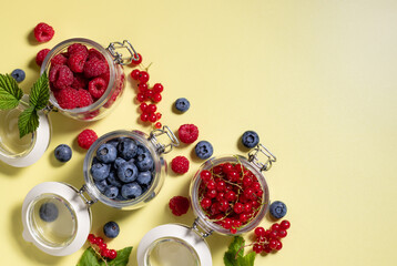 fresh seasonal raspberries, blueberries, red currants on colored background. Clean eating, detox food. space for text