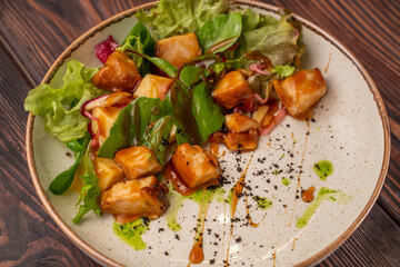 teriyaki chicken salad, green salad, bell pepper, on a white flat plate