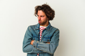 Young caucasian man isolated on white background tired of a repetitive task.