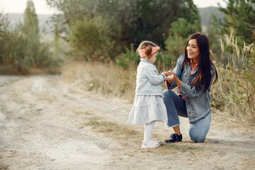 Fototapeta premium Mother with little daughter playing in a autumn field