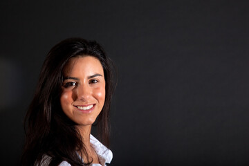 Portrait of a beautiful young woman on a dark background