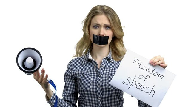 Woman holding card with inscription Freedom of speech.