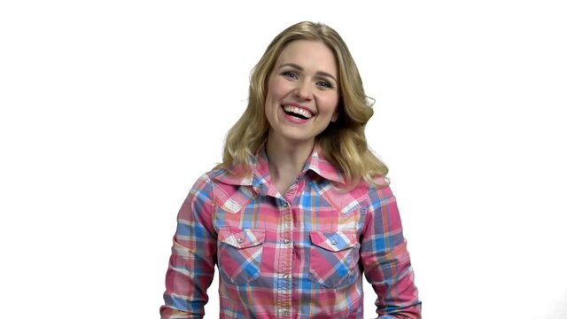 Young delighted woman is laughing on white background.