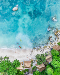 Tourists kayaking on clear blue tropical water near the beach with copy space, Koh Tao, Thailand,...