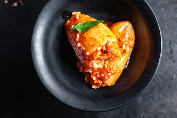 pepper filling rice and vegetables tomato sauce stuffed cabbage rolls fresh vegetable in plate on the table meal snack copy space food background rustic. top view keto or paleo diet 