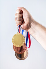 Hand with medals celebrating Olympic games success