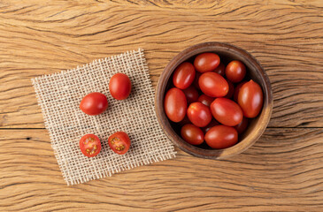 Cherry tomatoes on a bowl over wooden table