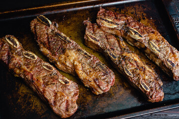 Grilled Beef Short Ribs on a Sheet Pan: Barbecue flanken beef ribs with a rustic background
