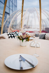 served table in a cafe on the roof in the form of a igloo.