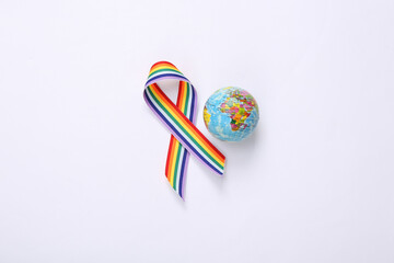 Globe with LGBT rainbow ribbon pride tape symbol on white background. Love and Tolerance concept