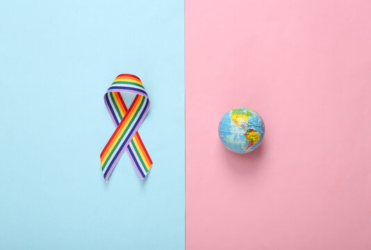 Globe with LGBT rainbow ribbon pride tape symbol on pink blue background. Love and Tolerance concept