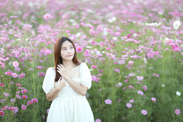 Beautiful young woman with white dress on garden background