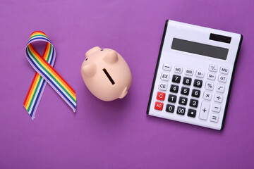 Calculator with piggy bank and LGBT rainbow ribbon pride tape symbol on purple background. Top view