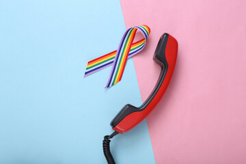 Phone tube and LGBT rainbow ribbon pride tape symbol on pink blue background.