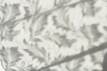 background and texture of gray linen fabric with plant shadows..