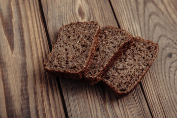 Fototapeta na wymiar Sliced whole grain rye bread on wooden table