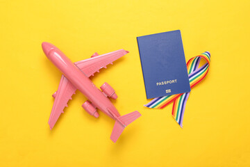 Travel concept. Passport with LGBT rainbow ribbon pride tape symbol and plane on yellow background....