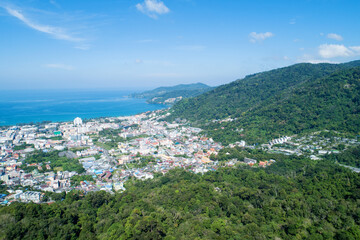 Fototapeta na wymiar Aerial view blue ocean and blue sky with mountain in the foreground at Patong Bay of Phuket Thailand Landscape of patong city phuket in sunny summer day time Beautiful tropical sea High angle view
