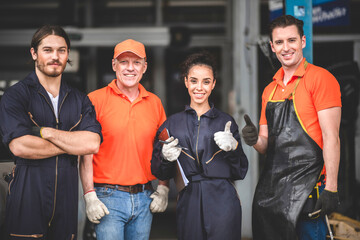 a portrait group photo of machanic team smilling in front of garage with thumb up, the professional...