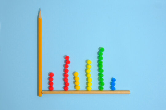Bar graphs of rainbow balls on a light blue background.