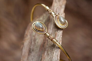 Brass metal mineral stone detail elegant bracelet on natural background