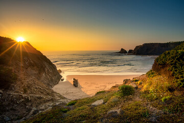 Landscape with sunset over Portuguese West coast and sandy Praia das Adegas