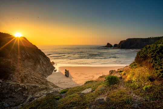 Landscape with sunset over Portuguese West coast and sandy Praia das Adegas