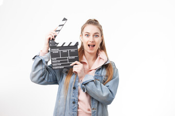 Young emotional woman holding a clapperboard on white background