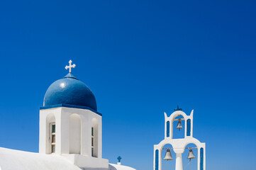 White and blue bell tower of the traditional Greek Orthodox church on the island of Santorini. Blue...