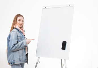 Young woman student in denim clothes and white board isolated on white background. Education concept