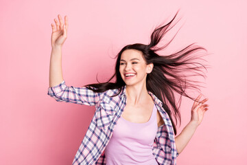Photo of joyful young lady look empty space wear plaid shirt isolated on pink color background