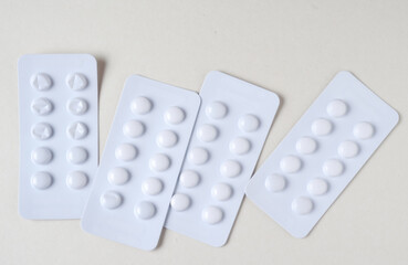 The white packs of pills on white