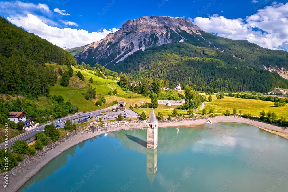 Wall mural submerged bell tower of curon at graun im vinschgau on lake reschen alpine landscape aerial view,