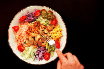 Chicken Salad. healthy foods. chicken, kale, carrot, purple cabbage, jalapeno pepper, corn. Healthy Eating Catal. fork and hand reaching for salad
